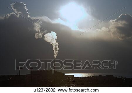 Stock Image - Factory smokestack emitting smoke. Fotosearch
