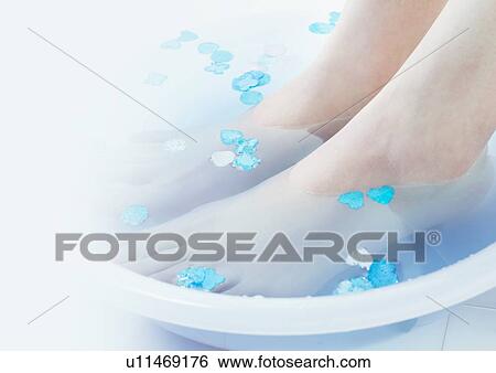 Stock Photograph - Feet in a bowl of water. Fotosearch