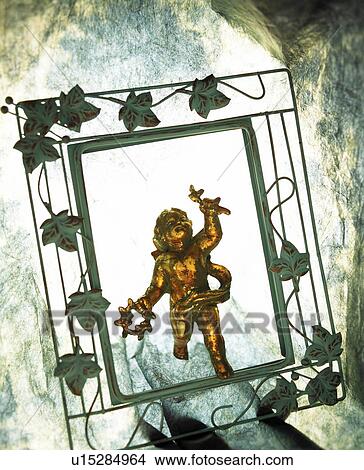 Picture - Figurine of angel in picture frame. Fotosearch