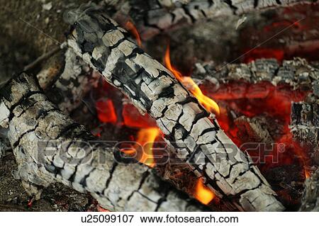 Stock Photo - Fire burning in a sunken hearth. Fotosearch