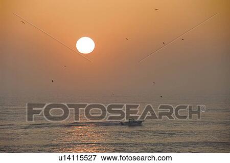 Stock Photo - Fishing Boat in the Sea at Dawn. Fotosearch