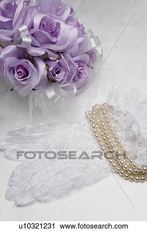 Stock Image - Flower bouquet and lace gloves with string of pearls, white background. Fotosearch