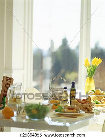 Food arranged on table near window View Large Photo Image Stock Photography - Food arranged on table near window. Fotosearch