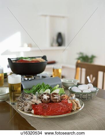 Food to be cooked in table top burner View Large Photo Image Picture - Food to be cooked in table top burner. Fotosearch