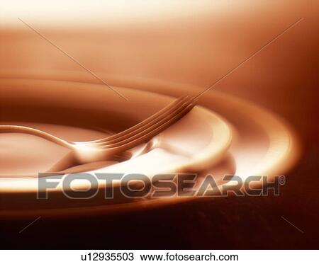 Stock Image - Fork on plates, close up. Fotosearch