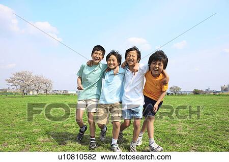 Four boys laughing with arms around each other on field. Futako-tamagawa, Setagaya-ku, Tokyo Prefecture, Japan View Large Photo Image Stock Image - Four boys laughing with arms around each other on field. Futako-tamagawa, Setagaya-ku, Tokyo Prefecture, Japan. Fotosearch