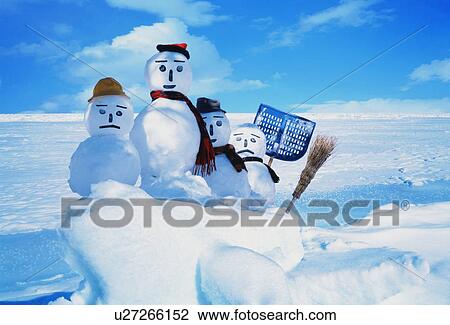 Stock Image - Four snowmen with tools in the snow. Fotosearch