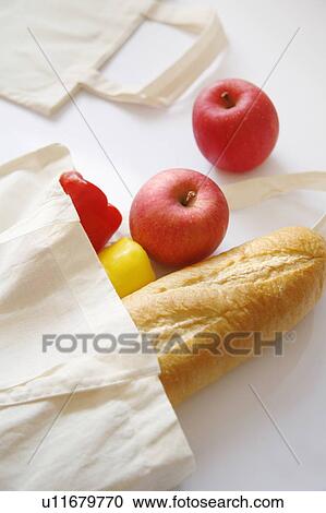 Stock Image - Fresh fruit and bread in an eco-friendly shopping bag. Fotosearch