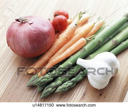 Stock Image - Fresh vegetables on a cutting board. Fotosearch