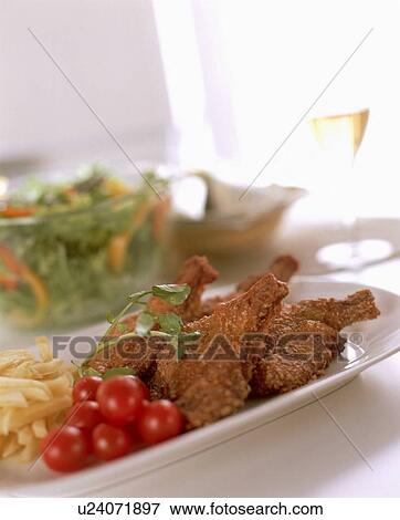 Stock Photo - Fried chicken with tomatoes and potato fries. Fotosearch