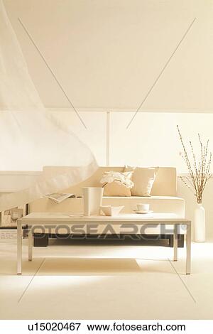 Stock Photo - Furnished living room with curtain in breeze. Fotosearch
