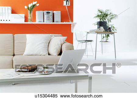 Stock Photography - Furnished living room with orange wall. Fotosearch