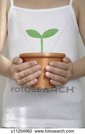 Girl holding potted plant View Large Photo Image Stock Image - Girl holding potted plant. Fotosearch