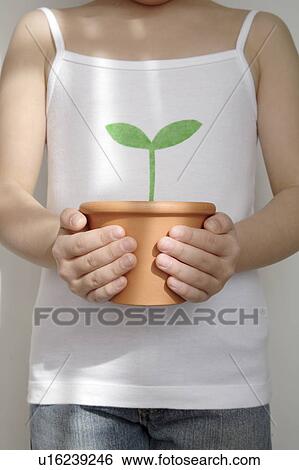 Stock Photograph - Girl holding potted plant. Fotosearch