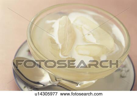 Stock Photo - Glass of coconut milk and syrup, close up, pink background. Fotosearch