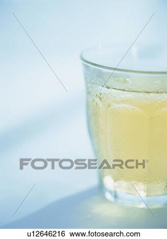 Stock Photograph - Glass of iced tea, blue background. Fotosearch