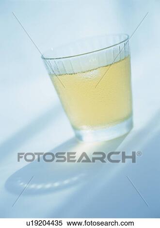 Stock Photography - Glass of iced tea, blue background. Fotosearch