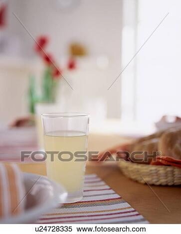 Glass of lemonade on table View Large Photo Image Stock Photography - Glass of lemonade on table. Fotosearch