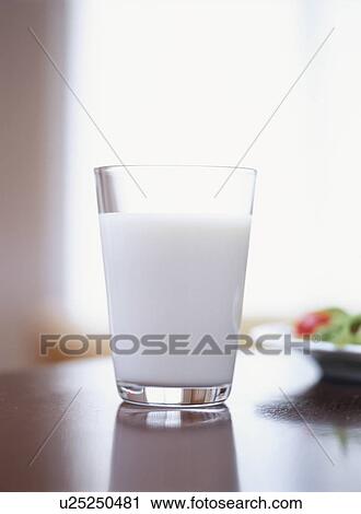 Stock Image - Glass of milk on table. Fotosearch
