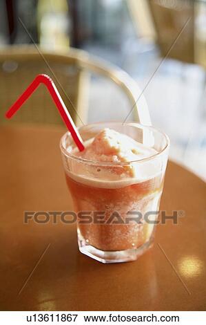 Stock Photo - Glass of orange juice with crushed ice. Fotosearch