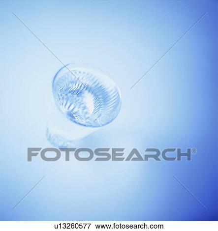 Stock Photo - Glass of water, blue background. Fotosearch