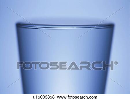 Glass of water, close up, blue background View Large Photo Image Stock Photo - Glass of water, close up, blue background. Fotosearch