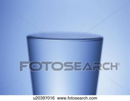 Glass of water, close up, blue background View Large Photo Image Stock Photograph - Glass of water, close up, blue background. Fotosearch