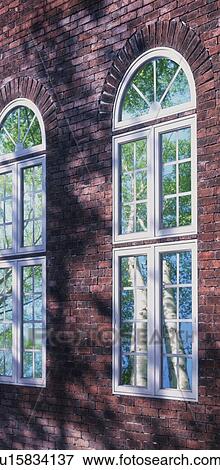 Stock Photo - Glass windows in brick building exterior. Fotosearch