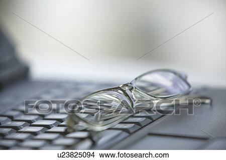 Glasses on computer keyboard View Large Photo Image Picture - Glasses on computer keyboard. Fotosearch