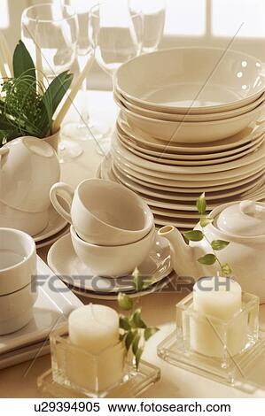 Glassware and crockery stacked on a table with candles View Large Photo Image Stock Photography - Glassware and crockery stacked on a table with candles. Fotosearch