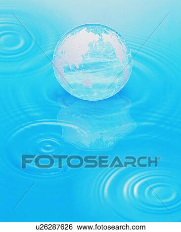 Stock Photograph - Globe floating on water surface. Fotosearch