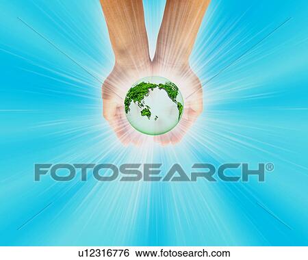 Stock Photograph - Globe glowing in hands. Fotosearch