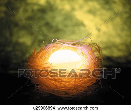 Glowing egg in a nest View Large Photo Image Picture - Glowing egg in a nest. Fotosearch