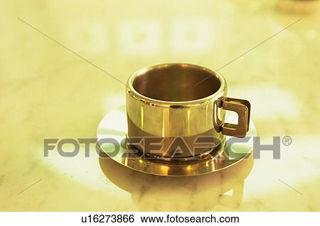 Gold coffee cup and saucer View Large Photo Image Stock Photograph - Gold coffee cup and saucer. Fotosearch