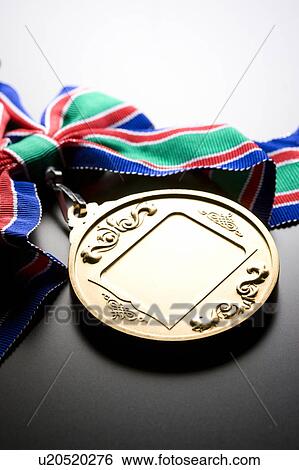 Stock Photograph - Gold medal with colorful ribbon. Fotosearch