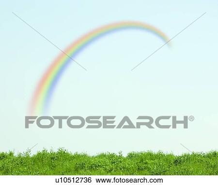 Stock Photograph - Green Field and Rainbow in Sky. Fotosearch