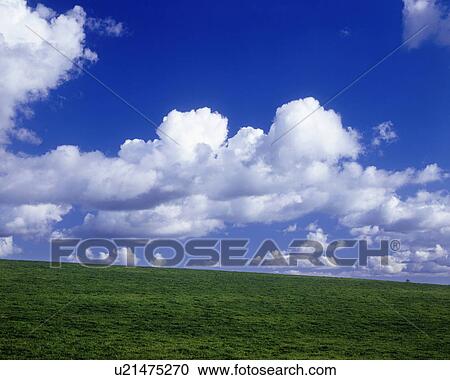Stock Image - Green Hilltop and Blue Sky. Fotosearch