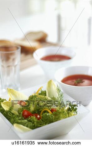 Stock Photography - Green salad and tomato soup. Fotosearch