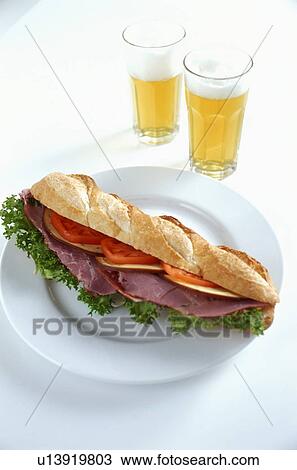 Stock Image - Ham, tomato and salad sandwich with two beers. Fotosearch