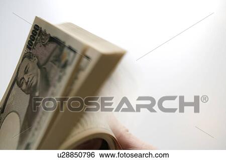 Stock Photograph - Hand counting Japanese yen. Fotosearch