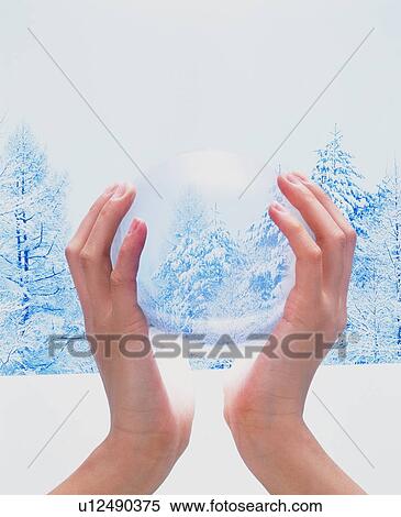 Hands cradling crystal ball in winter landscape View Large Photo Image Stock Photography - Hands cradling crystal ball in winter landscape. Fotosearch