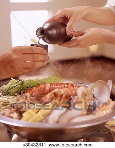 Hands pouring drink over seafood meal View Large Photo Image Stock Image - Hands pouring drink over seafood meal. Fotosearch