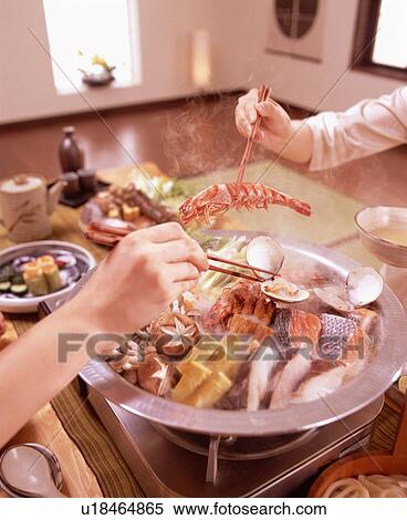 Hands serving seafood from dish with chopsticks View Large Photo Image Stock Photography - Hands serving seafood from dish with chopsticks. Fotosearch