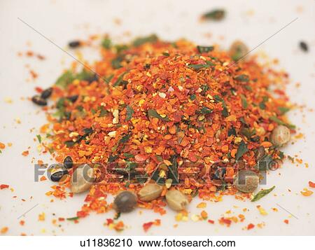 Stock Image - Heap of spice, close up, white background. Fotosearch