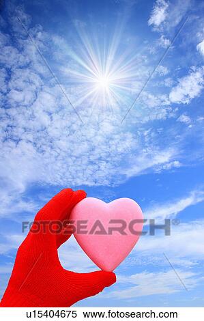 Stock Photography - Heart Shape Held up to the Sky. Fotosearch