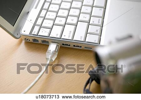 Stock Image - Home video camera attached to laptop. Fotosearch