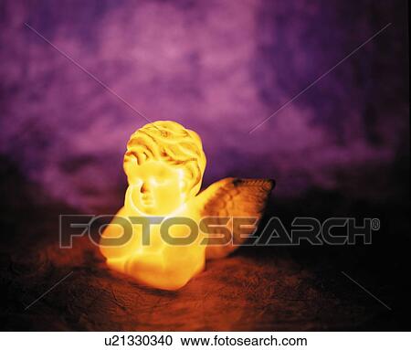 Stock Image - Illuminated angel lamp. Fotosearch