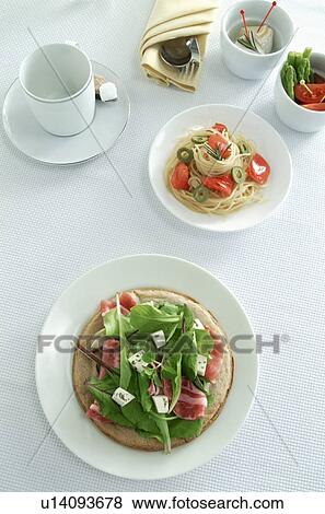 Stock Photo - Italian pasta and salad dishes with coffee cup. Fotosearch