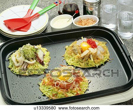 Japanese pancakes containing variety of ingredients on hot plate View Large Photo Image Stock Image - Japanese pancakes containing variety of ingredients on hot plate. Fotosearch