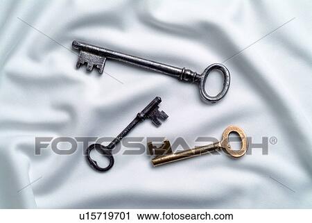 Stock Image - Keys on white silk. Fotosearch